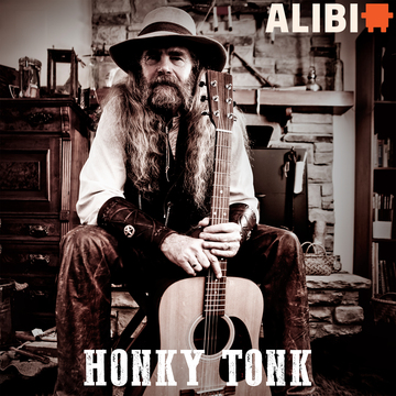 Man siting with an acoustic guitar