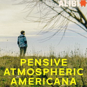 Person standing in a field looking to the distance