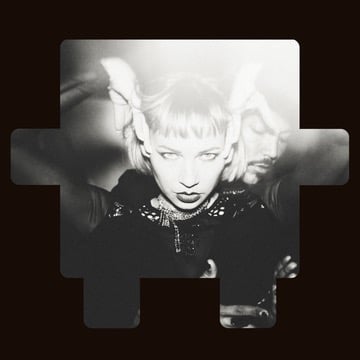 Black-and-white portrait of a person posing with hands in their hair