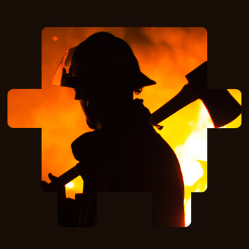 A silhouette of a firefighter with a blaze in the back