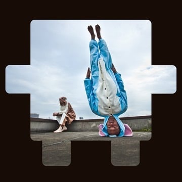 Person in a blue animal costume doing a headstand outdoors