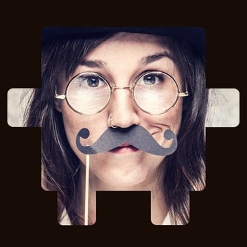 Person with glasses holding a fake mustache prop