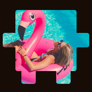 Person in a pool with a pink flamingo inflatable