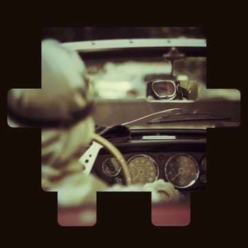 Driver’s view inside a vintage car looking through the windshield